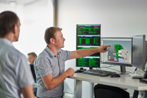 Engineer looking at screen with gear